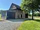 Rustic barn with natural wood, gravel driveway, and open bay design at 8365 Aaron Creek Church Rd, Oxford, NC 27565