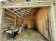 Barn interior with wooden beams, open storage, and a rustic, utility space at 8365 Aaron Creek Church Rd, Oxford, NC 27565
