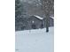 Snowy countryside barns featuring an American flag on a rustic facade in a serene, winter landscape at 8365 Aaron Creek Church Rd, Oxford, NC 27565