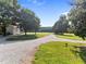 Exterior view of home featuring a long driveway, expansive lawn, and mature trees, showcasing the property's curb appeal at 8365 Aaron Creek Church Rd, Oxford, NC 27565