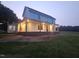 Charming two-story home with a covered porch, illuminated by the evening glow at 8365 Aaron Creek Church Rd, Oxford, NC 27565