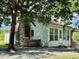 Charming house with stone chimney, sunroom, and covered porch nestled among mature trees at 8365 Aaron Creek Church Rd, Oxford, NC 27565