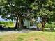 Charming home exterior with mature trees and a serene country setting at 8365 Aaron Creek Church Rd, Oxford, NC 27565