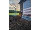 Close-up of a chicken next to a patriotic barn scene with an American flag and a vintage windmill at 8365 Aaron Creek Church Rd, Oxford, NC 27565