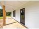 A covered front porch and front door with a view of the expansive front yard at 8365 Aaron Creek Church Rd, Oxford, NC 27565