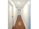 Hallway featuring wood floors and white doors with updated trim at 8365 Aaron Creek Church Rd, Oxford, NC 27565