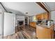 Inviting kitchen with wood floors, stainless appliances, and a brick fireplace, perfect for gatherings at 8365 Aaron Creek Church Rd, Oxford, NC 27565