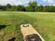 Expansive grassy land with a septic tank in the foreground and a treeline in the background at 8365 Aaron Creek Church Rd, Oxford, NC 27565