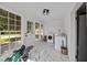 Bright laundry room with marble-style tile flooring, large windows and modern washer and dryer at 8365 Aaron Creek Church Rd, Oxford, NC 27565