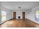Spacious living room with hardwood floors, a fireplace, and neutral walls, offering a cozy atmosphere at 8365 Aaron Creek Church Rd, Oxford, NC 27565