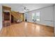 Open living room featuring hardwood floors, a wooden staircase, white walls, and lots of natural light at 8365 Aaron Creek Church Rd, Oxford, NC 27565