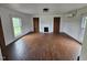 Charming living room with original hardwood floors, a decorative fireplace, and bright windows at 8365 Aaron Creek Church Rd, Oxford, NC 27565