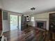 Cozy living room featuring a brick fireplace and stainless refrigerator at 8365 Aaron Creek Church Rd, Oxford, NC 27565