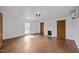 Bright living room with hardwood floors, fireplace, light walls and modern climate control unit at 8365 Aaron Creek Church Rd, Oxford, NC 27565