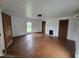 Charming living room with original hardwood floors, a decorative fireplace, and bright windows at 8365 Aaron Creek Church Rd, Oxford, NC 27565
