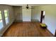 Spacious living room with hardwood floors, bright windows, and a ceiling fan at 8365 Aaron Creek Church Rd, Oxford, NC 27565