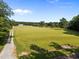 Picturesque property featuring a well-maintained gravel driveway leading to a classic farmhouse with lush pasture at 8365 Aaron Creek Church Rd, Oxford, NC 27565