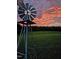 Historic windmill standing tall in a lush green field at sunset, creating a beautiful rural scene at 8365 Aaron Creek Church Rd, Oxford, NC 27565