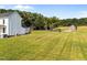 Exterior view of home and barn, highlighting the extensive lawn and grounds, showcasing the property's spaciousness at 8365 Aaron Creek Church Rd, Oxford, NC 27565