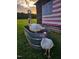 Two white turkeys are the stars of this farmyard scene with a rustic flag and vintage windmill at 8365 Aaron Creek Church Rd, Oxford, NC 27565
