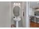 Stylish powder room boasts a pedestal sink, updated lighting, and modern fixtures at 8404 Saltwood Pl, Raleigh, NC 27617