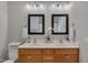 Bathroom featuring double sinks, framed mirrors, and ample counter space and storage at 8404 Saltwood Pl, Raleigh, NC 27617