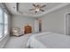 Relaxing bedroom with neutral colors, a tray ceiling, and ample natural light at 8404 Saltwood Pl, Raleigh, NC 27617