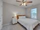 Cozy bedroom with a ceiling fan, soft carpet, and natural light from the window at 8404 Saltwood Pl, Raleigh, NC 27617