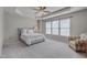 Tranquil bedroom with tray ceiling, neutral colors, and a comfortable seating area at 8404 Saltwood Pl, Raleigh, NC 27617