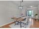 Dining area features a stylish table set, elegant lighting fixture, and wood flooring at 8404 Saltwood Pl, Raleigh, NC 27617