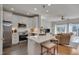 Modern kitchen with white cabinets, stainless appliances, an island, and open living space at 8404 Saltwood Pl, Raleigh, NC 27617