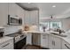 Bright kitchen features stainless appliances, white cabinets, subway tile, and an open floorplan at 8404 Saltwood Pl, Raleigh, NC 27617