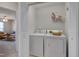 Convenient laundry area with modern washer and dryer set and functional shelving at 8404 Saltwood Pl, Raleigh, NC 27617