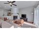Inviting living room featuring a fireplace, hardwood floors, and an open layout at 8404 Saltwood Pl, Raleigh, NC 27617