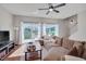 Spacious living room boasts hardwood floors, large sectional, and access to outdoor patio at 8404 Saltwood Pl, Raleigh, NC 27617