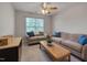 Inviting living room features neutral tones, a ceiling fan and lots of natural light at 8404 Saltwood Pl, Raleigh, NC 27617
