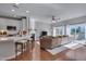 Open-concept living room with hardwood floors, fireplace, and sliding glass doors at 8404 Saltwood Pl, Raleigh, NC 27617