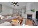 Comfortable living room with fireplace, hardwood floors, and open staircase at 8404 Saltwood Pl, Raleigh, NC 27617
