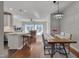 Open-concept living area boasts hardwood floors connecting kitchen, dining, and living spaces at 8404 Saltwood Pl, Raleigh, NC 27617