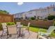 Back patio area with dining table, chairs, and a view of the property's green space at 8404 Saltwood Pl, Raleigh, NC 27617
