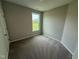 Bedroom with carpeted floors, natural light, neutral walls, and white trim at 90 Brookhaven Dr, Spring Hope, NC 27882