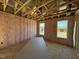 Insulated bedroom with natural light and exposed framing, awaiting finishing touches at 90 Brookhaven Dr, Spring Hope, NC 27882