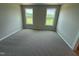 Cozy bedroom featuring plush carpeting, neutral walls, and a view of the yard at 90 Brookhaven Dr, Spring Hope, NC 27882