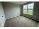 Bedroom features neutral walls, carpet, and window with neighborhood view at 90 Brookhaven Dr, Spring Hope, NC 27882
