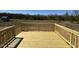 A spacious wooden deck with a railing provides an outdoor living space with a view of the backyard at 90 Brookhaven Dr, Spring Hope, NC 27882