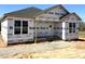 Exterior view of home under construction with visible weather-resistant barriers and window installation at 90 Brookhaven Dr, Spring Hope, NC 27882