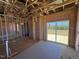 Spacious, unfinished room featuring exposed beams, insulation, and sliding glass doors to the exterior at 90 Brookhaven Dr, Spring Hope, NC 27882