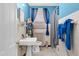 Compact bathroom featuring white tile, a vintage sink, and blue accents for a fresh, clean look at 940 Hill St, Rocky Mount, NC 27801