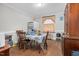 Dining area featuring wood floors, a classic china cabinet, a table setting, and natural light from the window at 940 Hill St, Rocky Mount, NC 27801