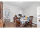 Simple dining area with wood floors, a classic china cabinet, a table setting, and easy access to the kitchen at 940 Hill St, Rocky Mount, NC 27801